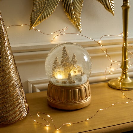 Boule à neige lumineuse ville diam 15 cm - Décor doré LED