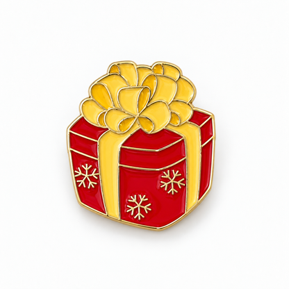 Pin's cadeau de Noël rouge et doré avec nœud et flocons, accessoire fantaisie festif pour veste ou sac femme