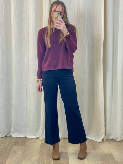 Jean wide leg taille haute bleu marine coupe flare porté avec pull bordeaux et bottines camel femme