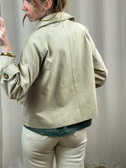 Trench court beige femme coupe oversize avec col relevé et boutons dorés, style vintage chic printemps