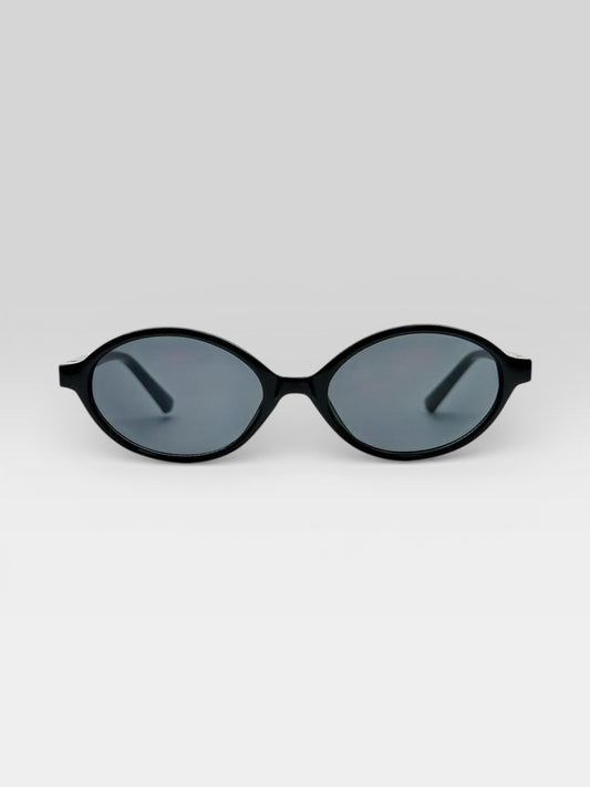 Lunettes de soleil ovales noires style rétro années 90 monture fine accessoire mode femme