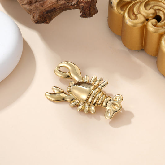 Broche homard dorée en métal brillant style marin accessoire fantaisie femme tendance