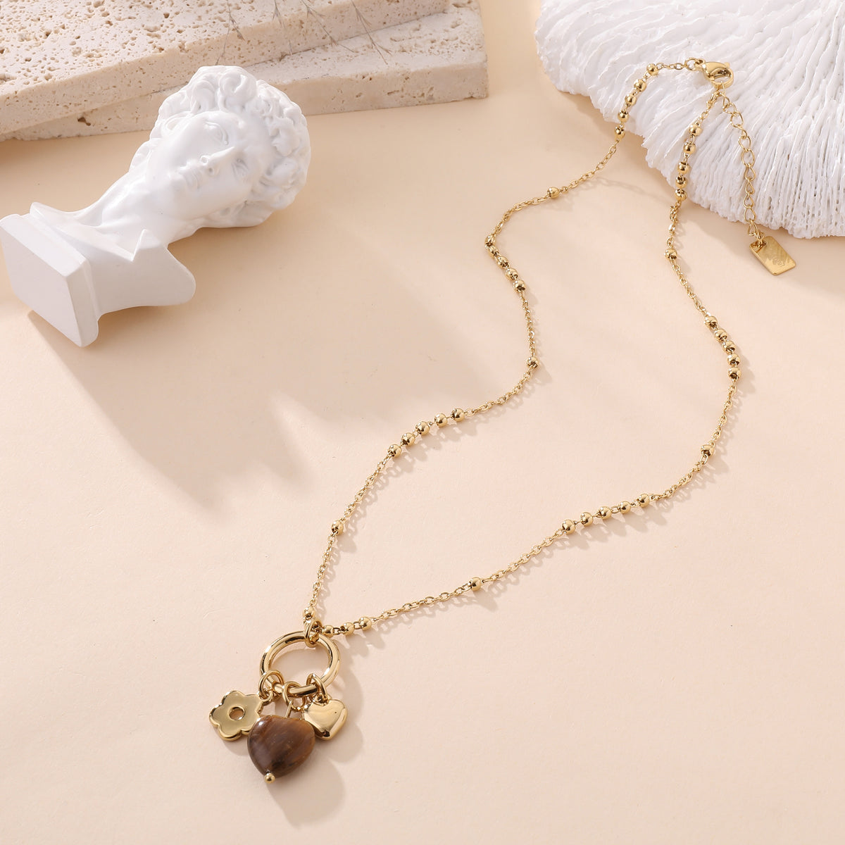 Collier chaîne dorée à perles avec pendentifs cœur œil de tigre et fleur bijou femme tendance