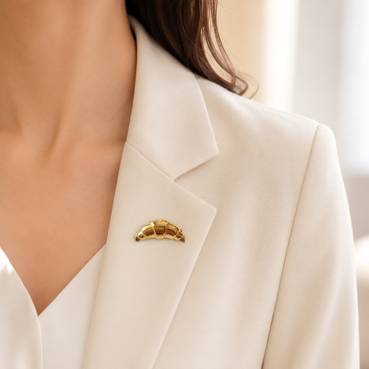 Broche croissant doré portée sur blazer blanc crème, accessoire fantaisie original femme style parisien chic