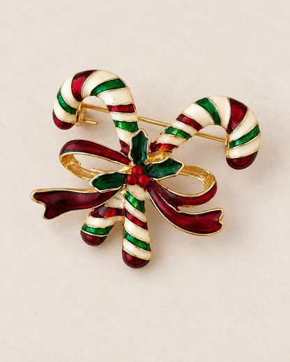 Broche sucre d'orge Noël dorée émaillée rouge vert et blanc avec noeud et houx accessoire festif femme