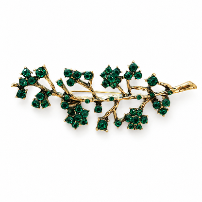 Broche branche dorée ornée de cristaux verts émeraude style nature élégante accessoire femme