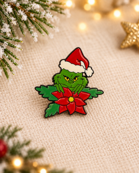 Pin's Grinch Noël émaillé vert et rouge avec bonnet Père Noël et poinsettia, accessoire fantaisie fêtes de fin d'année