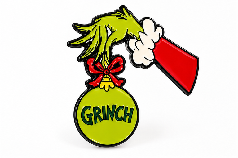 Pin's Grinch Noël vert main poilue tenant boule de sapin rouge accessoire fantaisie fêtes Dr Seuss