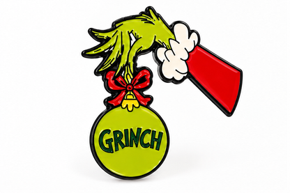 Pin's Grinch Noël vert main poilue tenant boule de sapin rouge accessoire fantaisie fêtes Dr Seuss
