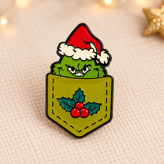 Pin's émaillé Grinch de Noël vert avec bonnet rouge dans poche à houx, accessoire fantaisie festif original